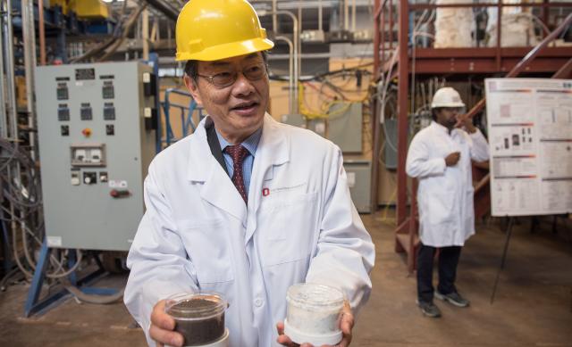 man in lab coat holding energy materials