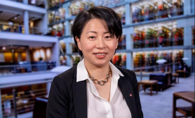headshot of a woman in suit in the library