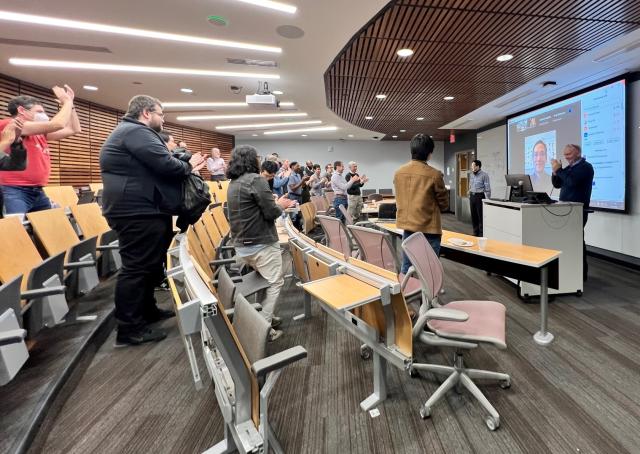 room of peers clapping for dr. zhang