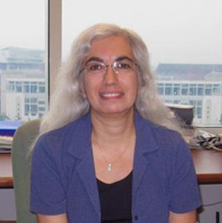 woman sitting in front of window in blue shirt