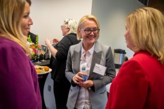 woman talking to two other women