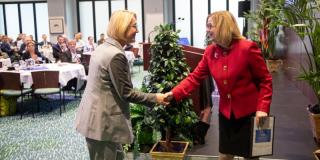 two women shaking hands