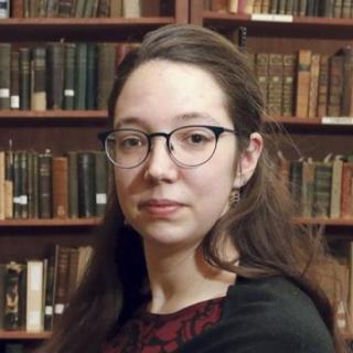 woman in front of bookshelf