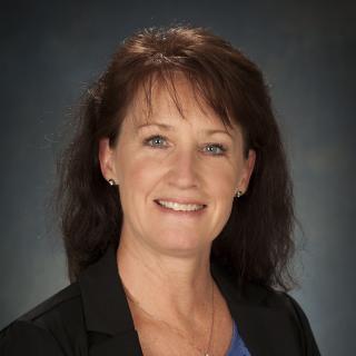 woman in blue shirt and black blazer