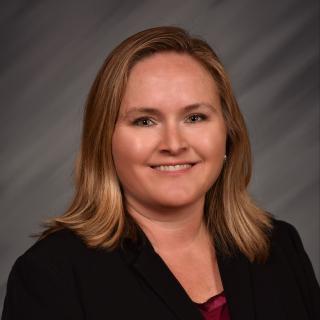 woman with brown hair in black jacket