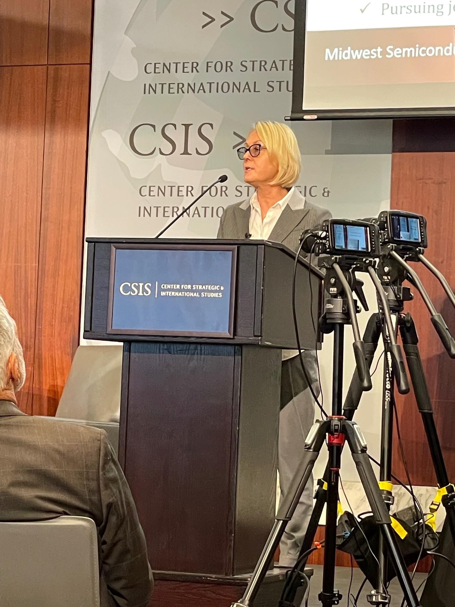 Dorota speaks from podium at the conference