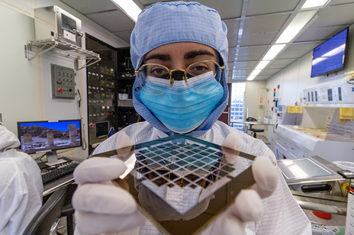 a person in a lab holds a semiconductor