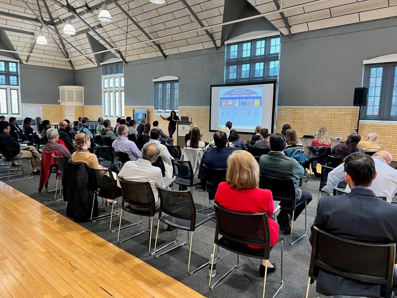 woman speaking to a room full of people