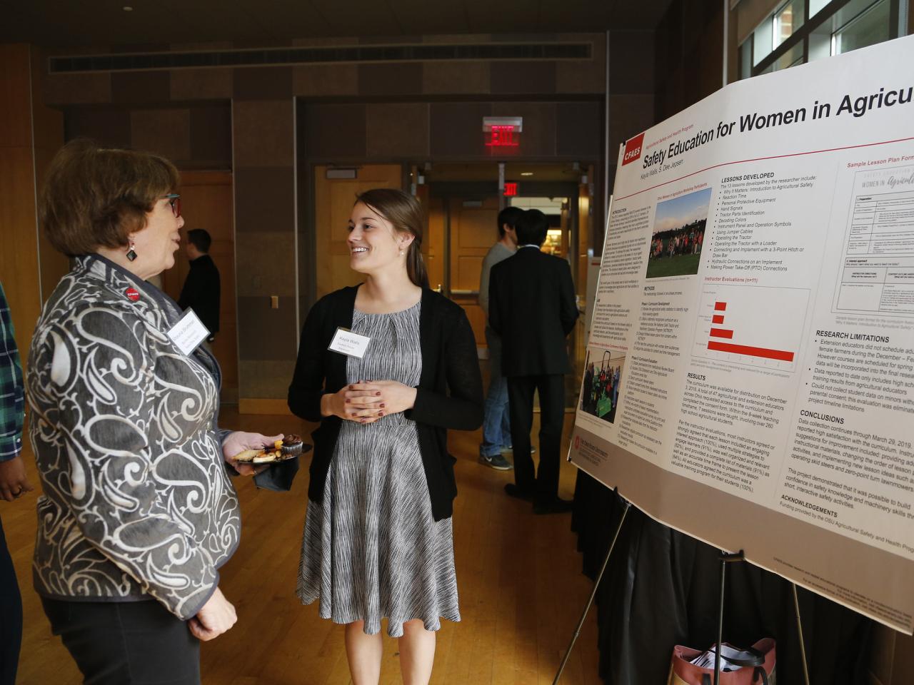 student presenting poster during networking reception