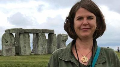 woman standing in front of stonehenge