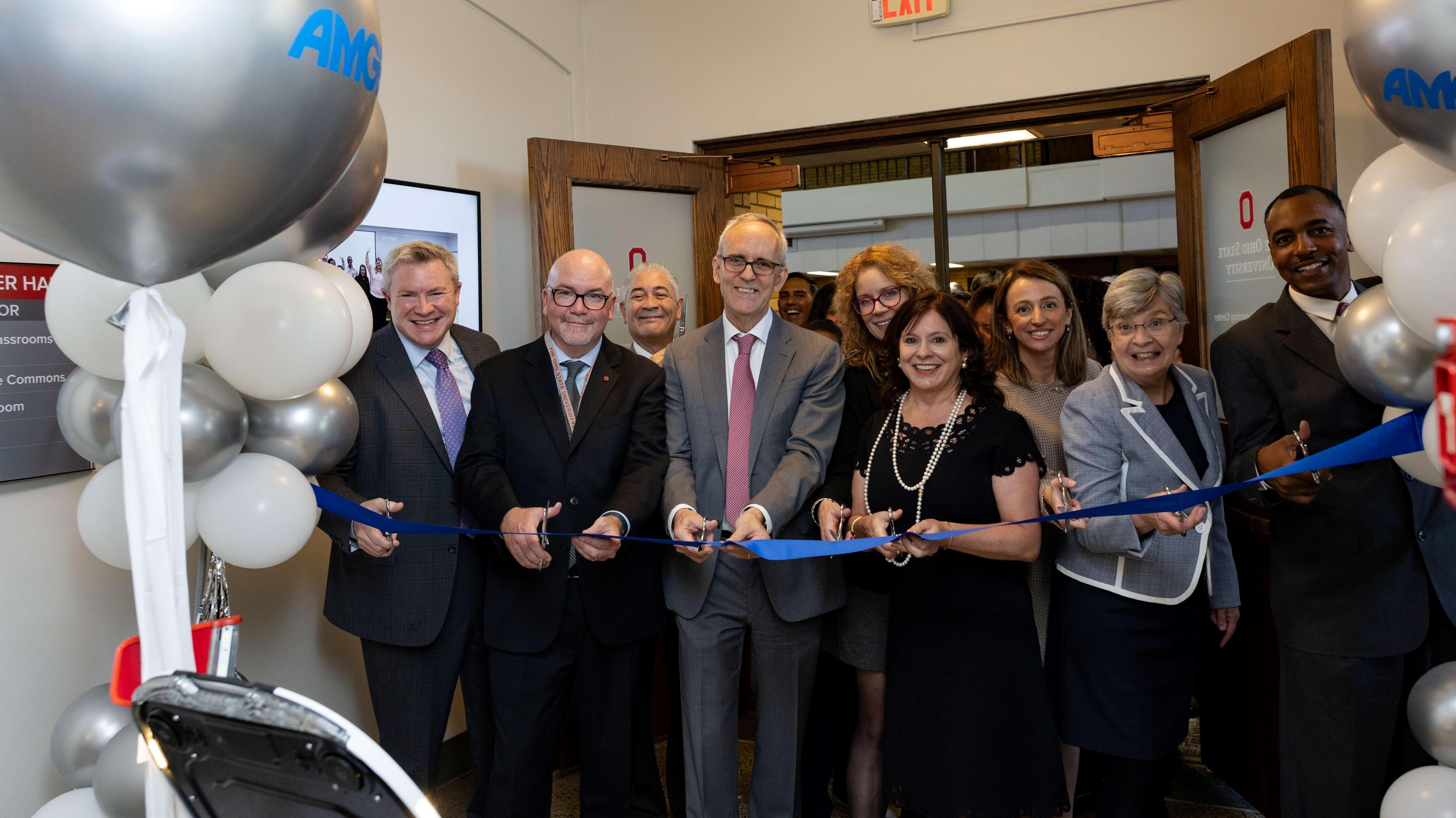 people cutting ribbon