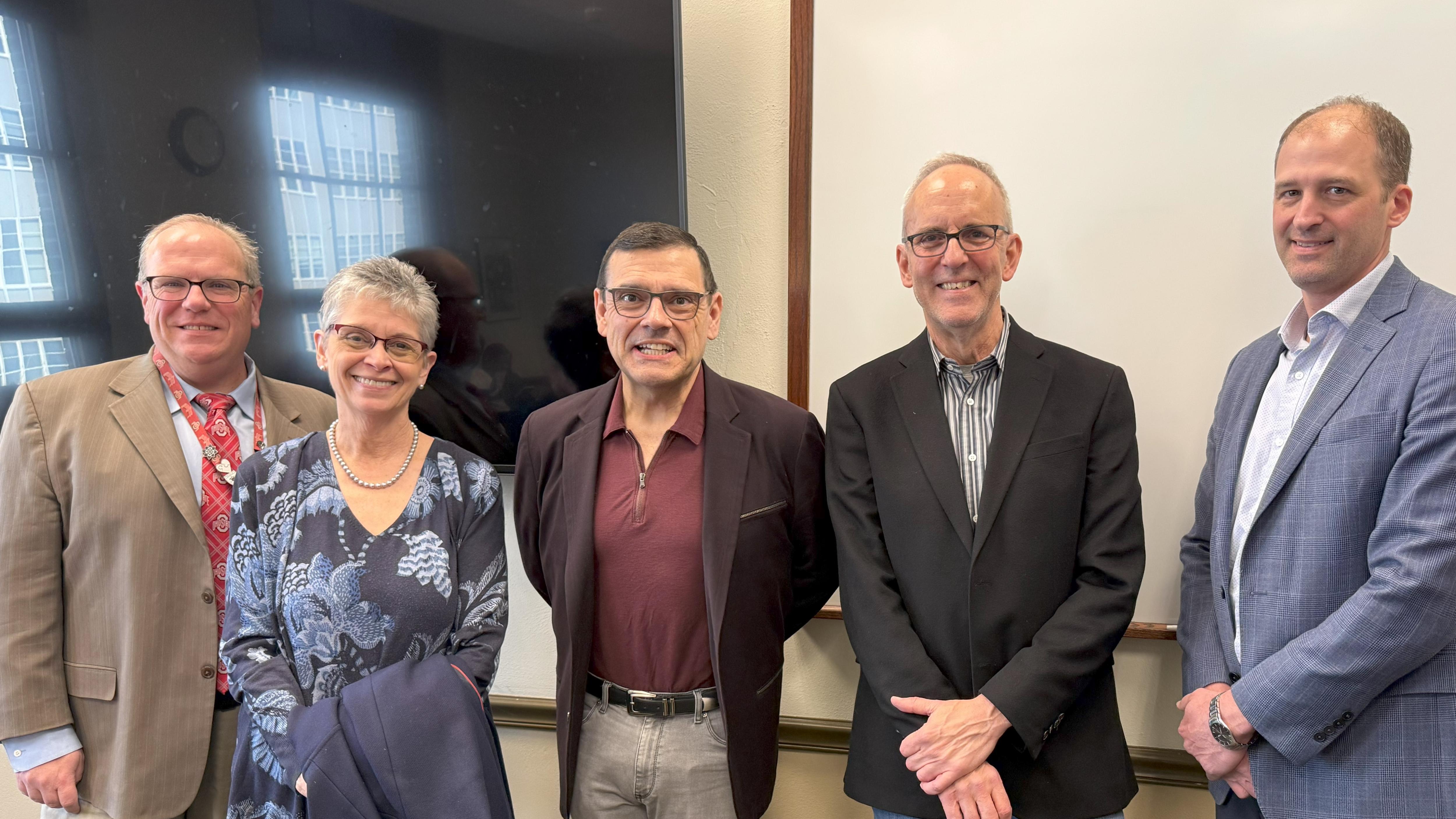 four leaders standing with awardee michael neblo