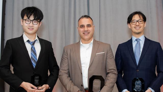 the three innovator of the year awardees holding their awards