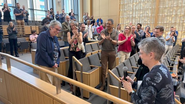 A room full of people clapping