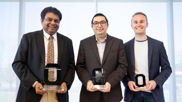 three men with awards